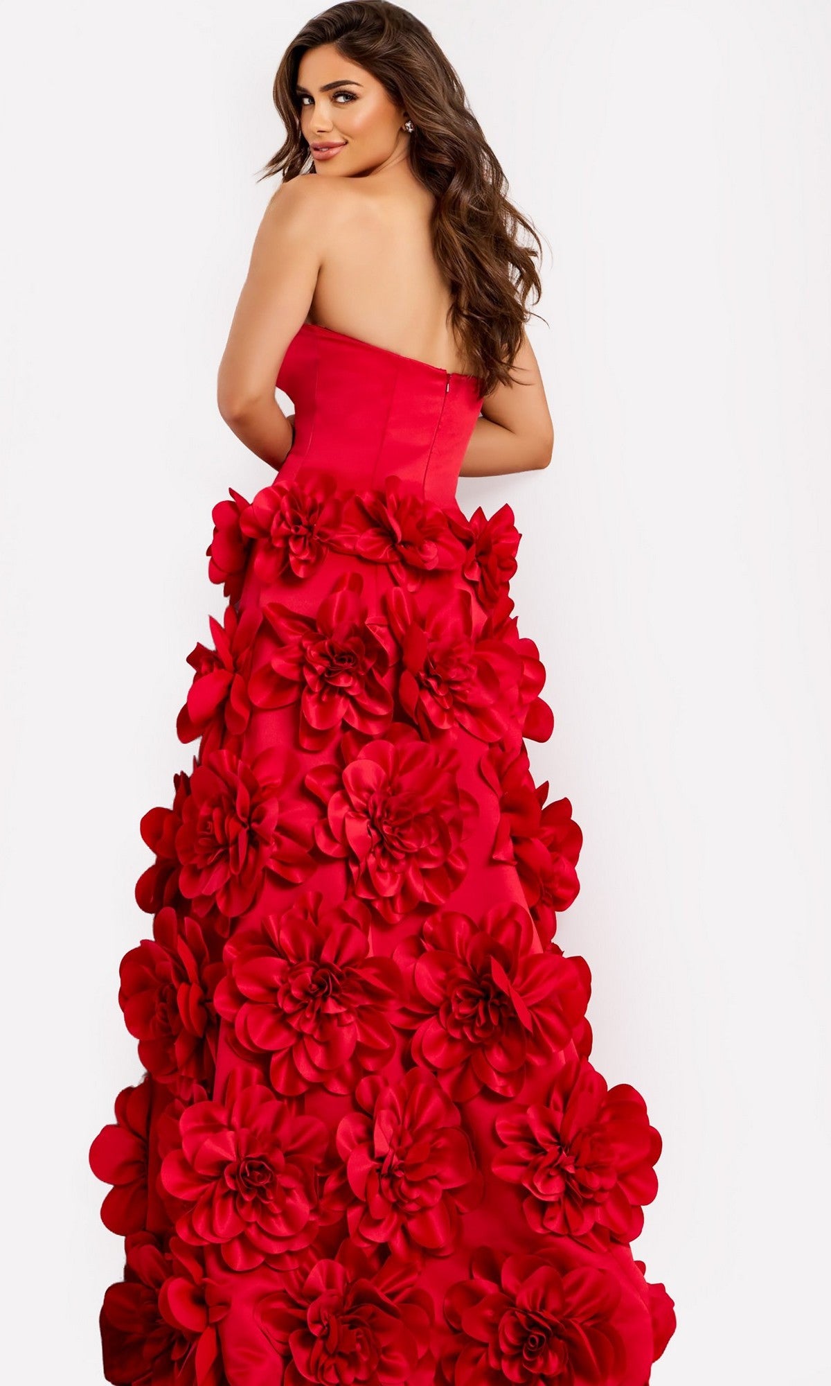 A woman models the Jovani 45661 long prom dress, showcasing its strapless sweetheart neckline and bold 3D floral appliques as she poses elegantly against a plain white background.